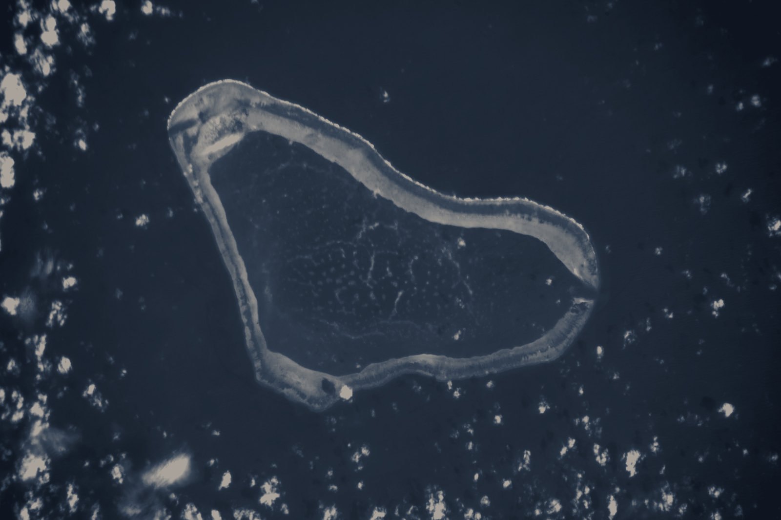 Scarborough Shoal seen from the International Space Station: a triangular coral ring enclosing a turquoise lagoon in the South China Sea